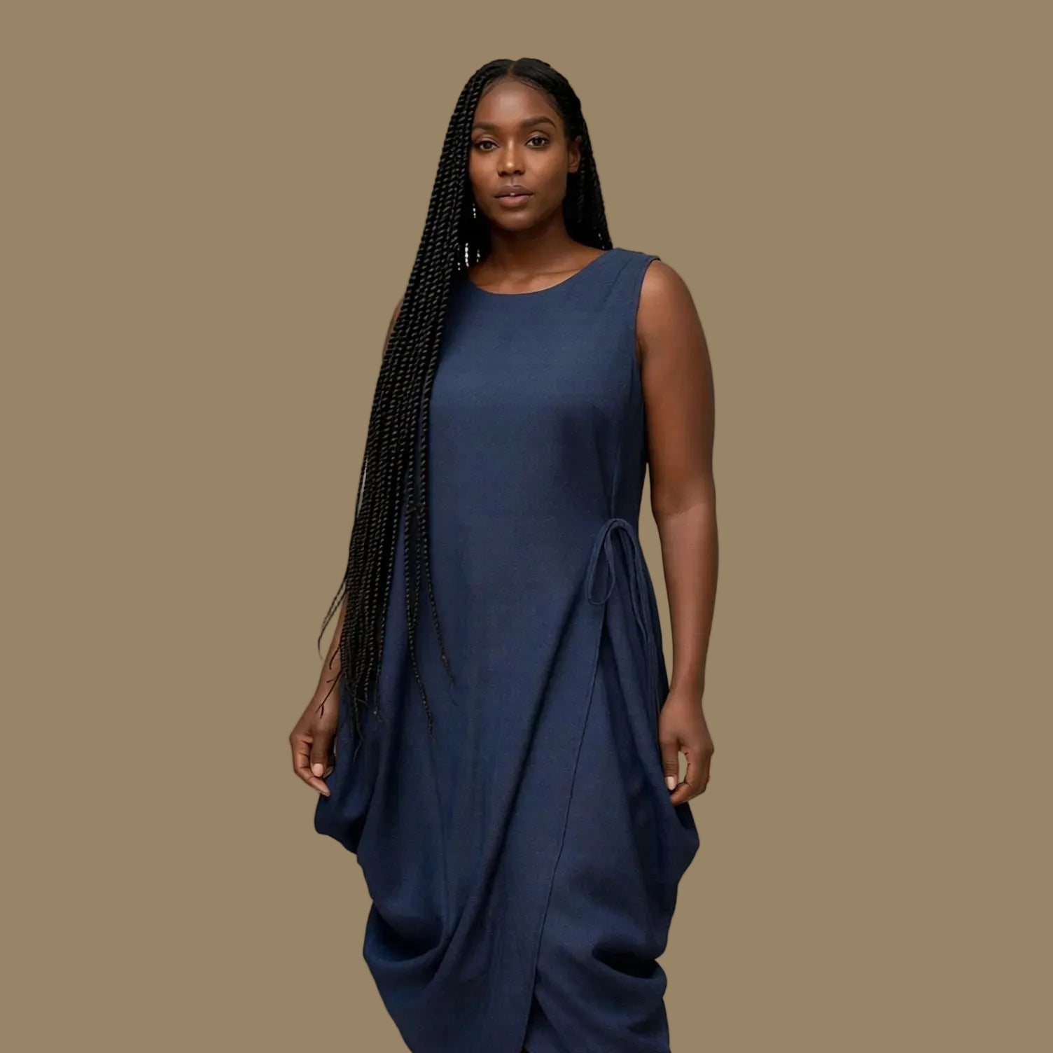 Woman wearing a navy blue dress against a plain background